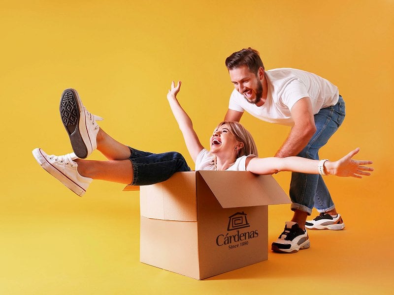 Couple having fun with a moving box