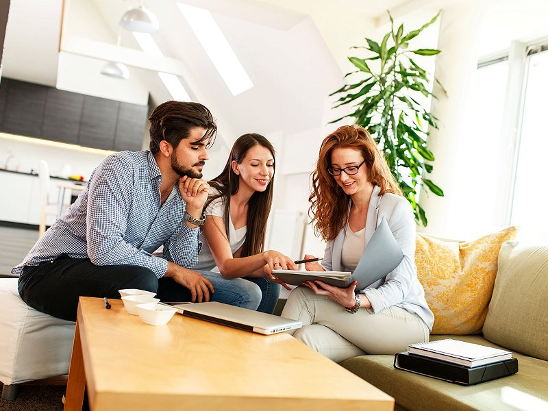 Young couple viewing a portfolio with a consultant