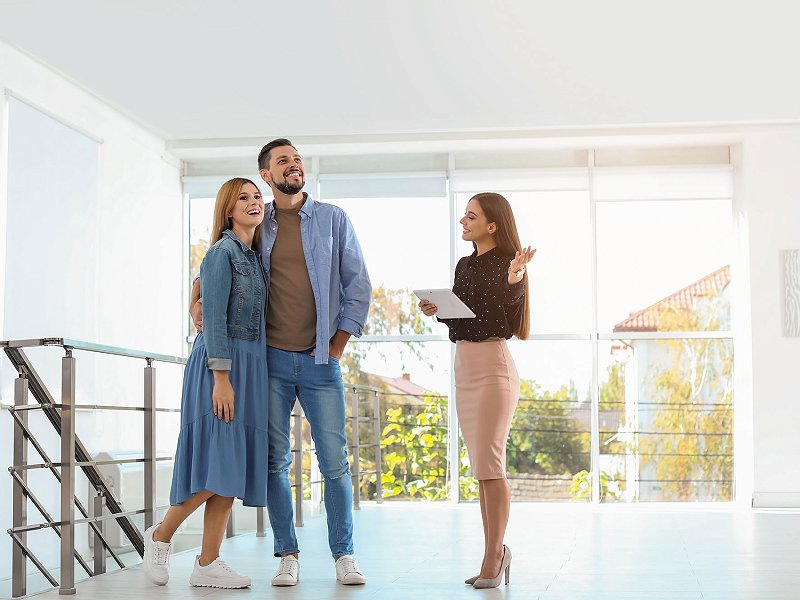 Real estate consultant showing a house to a couple