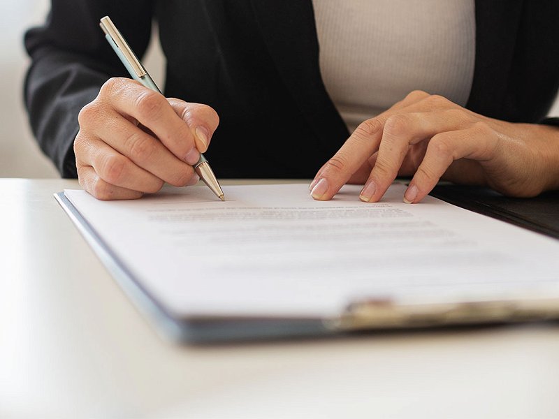 First plan of a woman signing document