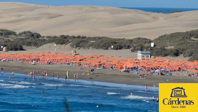 Playa del Inglés con personas en la arena y nadando