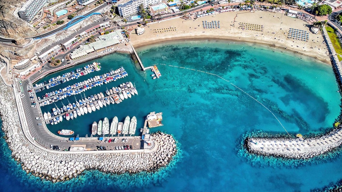 Puerto Rico, Gran Canaria, aerial view of the beach and harbour from above